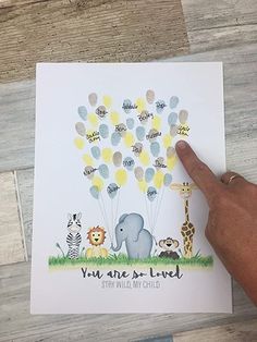 a hand pointing at an elephant and giraffe card with balloons in the sky