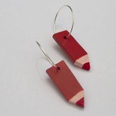 two pairs of red and pink pencil earrings