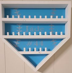 a white shelf with candles and snowflakes on it