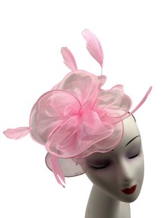 A Brand New light pink Colour Fascinator With cloth fabric forming a beautiful layered flower with a burst of feathers, thus making a beautifully crafted fascinator. Made up of cloth fabric and feathers The length of the fascintor is approximately 20cm and its width at the widest point is 19cm. This Fascinator comes in with a light pink colour headband and a metal clip as an attachment. These are removable and can be used according to your need. This allows you to wear the fascinator at differen Pink Feathered Fascinator For Races, Pink Feather Fascinator For Royal Ascot, Elegant Pink Hair Accessories For Royal Ascot, Pink Headband For Royal Ascot, Pink Feathered Headpieces For Summer, Pink Feathered Headpieces For Spring, Summer Pink Feathered Headpieces, Pink Hair Accessories For Kentucky Derby, Pink Headband For Summer