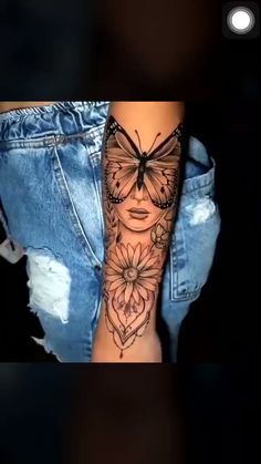 a woman's leg with a butterfly tattoo on it and flowers in the background