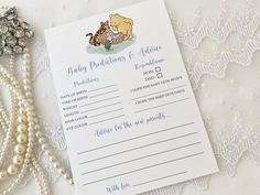 a baby dedication and advice card next to pearls