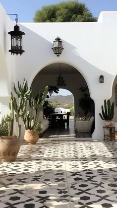 an outdoor patio with potted plants and hanging lights