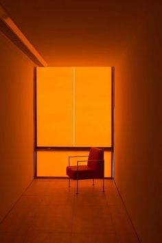 an orange room with a red chair in it