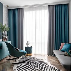 a living room with blue curtains and zebra print rug