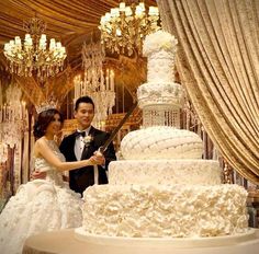 a newly married couple cutting their wedding cake