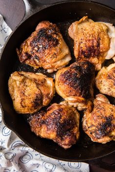 chicken thighs in a cast iron skillet ready to be cooked for the dinner guests