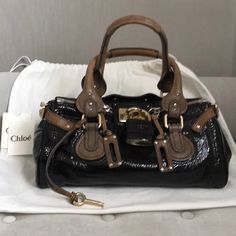 Authentic Chloe Paddington Bag. Minimal Scratches On Hardware. Mild Wear On One Bottom Corner But Otherwise In Excellent Condition. Comes With Dust Bag. Chloe Paddington Bag Outfit, Brown Nylon Shoulder Bag With Detachable Strap, Chloe Paddington Bag, Designer Brown Shoulder Bag With Turn-lock Closure, Chloe Black Crossbody Bag, Chloe Brown, Chloe Bags, Chloe Bag, Vintage Accessories