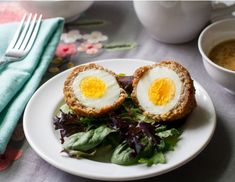 an egg is cut in half on top of a salad