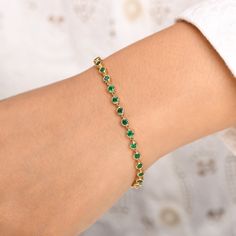 Natural emerald tennis bracelet in 14k 18k gold, 3mm 3-4ct Bezel set emerald link chain bracelet gold, Green gemstone emerald bracelet gold STONE DETAILS : ✦ Gemstone: Emerald ✦ Gemstone Type : Natural ✦ Gemstone Size : 3.00 mm ✦ Gemstone Shape : Round cut ✦ Number of gemstones : 30 ✦ Gemstone Weight : 3-4 carats ✦ Gemstone Grade : AAA METAL DETAILS : ✦ Metal : 14K/18K Gold ✦ Metal Color : Yellow / White / Rose Gold ✦ Setting : Bezel Setting ✦ Bracelet Box : Yes SHIPPING DETAILS : ✦ Shipped via Gold Emerald Bracelet, Classic Gold Tennis Bracelet With Emeralds, Fine Emerald Tennis Bracelet In Yellow Gold, Fine Jewelry Emerald Tennis Bracelet In Yellow Gold, Gold Tennis Bracelet As May Birthstone Gift, Flexible Tennis Bracelet As Fine Jewelry Gift, Gold Emerald Tennis Bracelet As A Gift, Emerald Gemstone Tennis Bracelet For Anniversary, Elegant Emerald Tennis Bracelet Gift