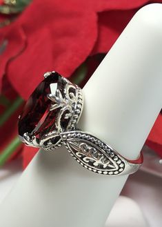 Garnet Ring Dragon Design #133 MADE TO ORDER This lovely sterling silver filigree ring is set with a stunning approximately 6ct Red Garnet CZ, {6ct Natural Garnet gemstone also available, see last picture in set}. The oval-cut Garnet gemstone is 14mm long by 10mm wide. The ring is 8mm off the finger. Notice the detailed design of the silver filigree setting and band. This is an exquisite rendition of a Gothic/Renaissance filigree ring... and is ready to wear. A ring gift-box is included. Feel fr Classic Oval Jewelry Stamped 925, Oval Garnet Jewelry With Intricate Design, Oval Garnet Rings, Luxury Silver Oval Ruby Ring, Classic Oval Cabochon Ruby Ring, Oval Garnet Filigree Jewelry, Luxury Oval Ruby Ring In Sterling Silver, Ornate Oval Rings For Gifts, Exquisite Oval Filigree Ring