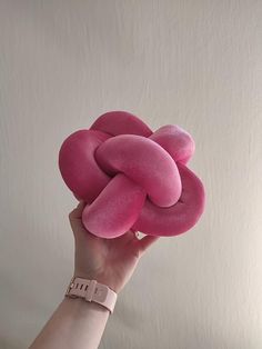 a person holding a pink object in their hand