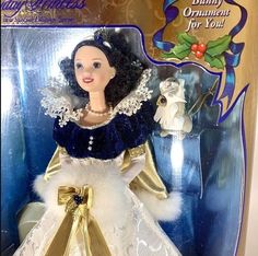 a barbie doll in a christmas dress with white and gold trimmings on it