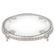 a round glass tray with silver trimmings on the bottom and an ornate design