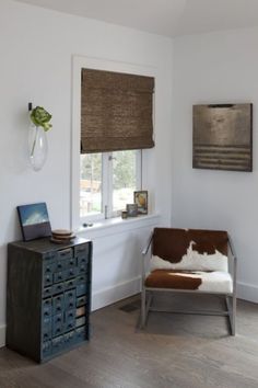 a living room with a cow hide chair