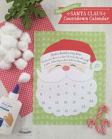 the santa claus calendar is next to some cotton balls and candy canes on a table