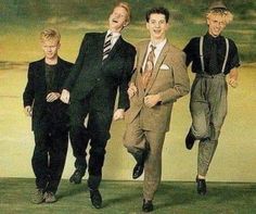 three men in suits and ties are walking together