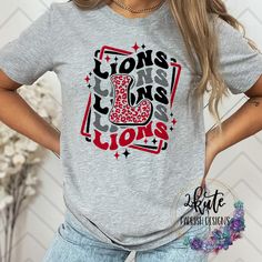 Pick yourself up one of these fun and spirit-filled Lions shirts. This shirt is sure to impress your friends and show your true Lions spirit. .  It's a soft shirt in an ash gray color with a midweight feel. This shirt is made of 95% polyester and  5% spandex. It's nice and soft with great stretch.  Some shirts may be 100% polyester depending on availability. To get the best wear from your shirt make sure to  1. Wash in cold water 2. Tumble dry low 3. Do not iron on design area 4. Do not use fabric softener This shirt is made by an ink print process. This specific shirt design is made to be a soft, vintaged look. Minor fading may occur after the first wash to enhance the vintage look School Spirit T-shirt For Game Day, Relaxed Fit, School Spirit T-shirt Relaxed Fit For Game Day, Relaxed Fit T-shirt For Game Day With School Spirit, Game Day School Spirit T-shirt With Heat Transfer Vinyl, Casual Game Day T-shirt With Sublimation Team Name, Casual Football Season Sublimation Design, Casual Sublimation Design With Letter Print For Game Day, Casual Red T-shirt For Cheerleading, Cheer School