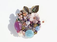 I designed and handcrafted this elegant brooch of flower crown that features natural Jades & Stones with mother of pearl.  A delicate cluster of stone beads are wire sculptured that would look more beautiful! Wonderful gift idea for Mother, Grandma, Daughter, Sister, Friend or for your self!! You can wear this as a pin or as a pendant on any chains.    - overall size : 60mm x 55mm  - All jewelry items come to you carefully gift-wrapped, ready for giving or as a special treat for yourself. Thank Handmade Flower Brooches As Gift, Handmade Flower Brooches For Gifts, Unique Flower Brooches For Jewelry Making, Unique Handmade Flower Brooch, Unique Handmade Flower Brooches, Unique Flower Shaped Brooches For Gift, Handmade Wedding Brooches, Handmade Round Wedding Brooches, Unique Handmade Anniversary Brooches