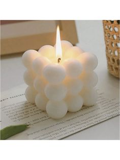 a white candle sitting on top of a table