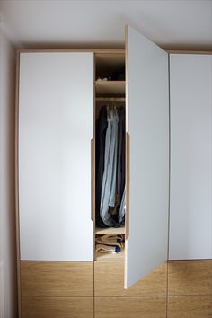 an open closet with clothes in it