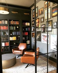 a living room filled with furniture and bookshelves covered in lots of bookcases