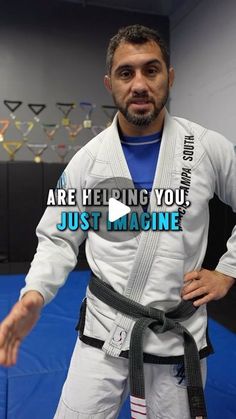 a man standing in front of a blue mat with the words are helping you just imagine