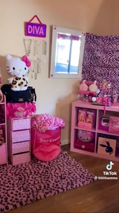 a hello kitty bedroom with pink furniture and zebra print rugs on top of the carpet