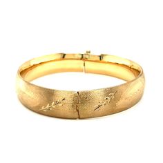 A classic floral carved high polish bangle crafted in 14k yellow gold with a hidden clasp. Product Details: Bangle Information : Metal : 14K Yellow Gold Clasp : Hidden Clasp Width : 0.53 in Approximate Weight: Size Weight 7'' 19.2 grams 8'' 20.5 grams Classic Etched Gold Bracelet For Formal Occasions, Classic Etched Gold Bracelet, Etched Yellow Gold Bracelet For Anniversary, Classic Etched Yellow Gold Bracelet, Elegant Etched Yellow Gold Cuff Bracelet, Elegant Etched Yellow Gold Bangle, Formal Gold Cuff Bracelet With Diamond Cut, Classic Etched Bangle For Formal Occasions, Classic Hinged Bangle For Formal Occasions