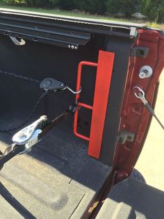 the inside of a truck with its door open and tools hooked up to it's side