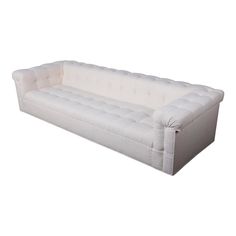 a white couch sitting on top of a white floor