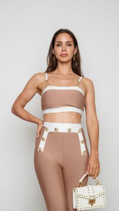 Introducing our Aida Two Piece Set, a perfect pairing of style and simplicity. The coordinated ensemble features a chic nude and white design that effortlessly transitions from casual to refined. Whether you wear the pieces together for a polished look or mix and match with other wardrobe staples, this set is a versatile and fashionable addition to your collection. Featured: Two Piece Set Cropped Top High Waisted Pants 78905 SET 38 Elegant Beige Two-piece Set, Elegant Beige Sets For Summer, Elegant Beige Summer Sets, Fitted Beige Two-piece Set, Chic Fitted Beige Set, Chic Beige Sets For Day Out, Chic Summer Sets, Chic Sets For Day Out, Chic Two-piece Loungewear Tops