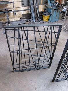 two metal structures sitting on top of a cement floor