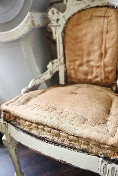 an old chair sitting on top of a wooden floor