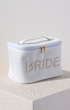 Carry all your cosmetic essentials for your big day in our "Bride" Cosmetic Case. This chic top-handle bag is embroidered with faux pearls and gold stitching and makes for the perfect makeup carrier every bride-to-be needs. Wedding Day Essentials, Chic Top, Wedding Registry, Perfect Makeup, Cosmetic Case, Handle Bag, White Bag, Cosmetic Bag, Big Day