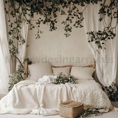 an unmade bed with white sheets, pillows and greenery on the headboard