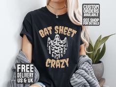 All T-shirts are Unisex. See Images for size charts. A Funny Halloween T-Shirt with the phrase 'Bat Sheet Crazy' and an image of a sheet ghost costume with bats printed on it. This T-Shirt gives off a festive and playful vibe, perfect for Halloween parties or events. It is relevant to those who enjoy humor and dressing up for the holiday. See more of our Halloween designs here  https://www.etsy.com/uk/shop/HeavyMetalCasualTees?ref=seller-platform-mcnav&section_id=49979763 See more of our T-Shirt Black Novelty Top With Custom Print, Halloween Band Merch Tops With Custom Print, Halloween Letter Print Fan Merchandise Top, Halloween Novelty Tops For Fans, Halloween Band Merch Tops With Letter Print, Halloween Novelty Top For Fan Merchandise, Halloween Novelty Tops With Screen Print, Halloween Custom Print Relaxed Top, Novelty Halloween Tops With Screen Print