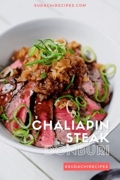 a white bowl filled with meat and vegetables