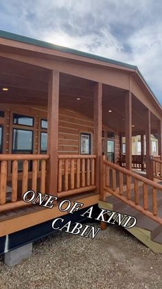 the front porch of a cabin with stairs leading up to it