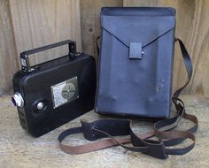 an old fashioned camera and case sitting on the ground