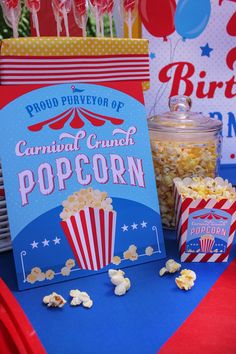 popcorn, pop corn and soda are on the table at a carnival themed birthday party