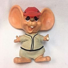 an elephant figurine wearing a baseball uniform