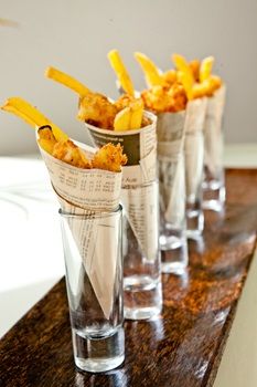 four glasses filled with food sitting on top of a wooden table next to each other