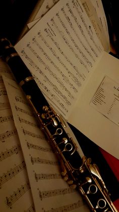 sheet music and flute lying on top of each other