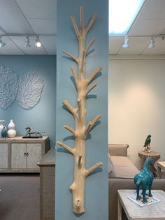 a sculpture of a tree is on the wall in an office setting with blue walls