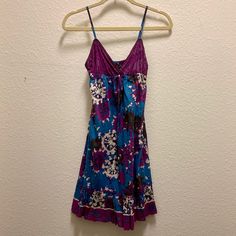 Perfect Condition! New With Tags! A Beautifully Designed Blue And Purple Strappy Dress. Excellent For Summer! There Is Some Beading Detail Throughout As Well. The Straps Are Adjustable, So You Can Make It Work For You! Brand: Rampage Condition. Brand New With Tags Size: S Purple V-neck Sundress For The Beach, Casual Purple Sundress For The Beach, Purple Floral Print Sundress For Vacation, Purple Floral Print Sundress For Beach, Purple V-neck Beach Sundress, Purple Mini Sundress For Vacation, Purple Mini Sundress For The Beach, Purple Cotton Mini Dress For Vacation, Purple Floral Print Mini Sundress