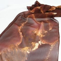 The colors in this light weight silk scarf are so striking! Ranging from a deep rust to fushia, orange, brown and tan - and everything in between, this scarf really is one of a kind! Dyed first with metal and then painted in layers to create depth, this scarf is a work of art! Measuring approximately 14" x 72" Dry Clean Only Brown Bohemian Silk Scarves, Bohemian Brown Silk Scarves, Bohemian Brown Silk Scarf, Silk Chiffon Scarves, Hand Dyed Silk, Chiffon Scarf, Silk Dyeing, Orange Brown, Silk Chiffon