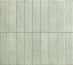 a white tile wall with vertical lines on it