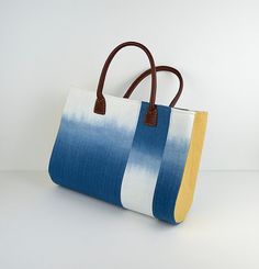 a blue and yellow bag sitting on top of a white table