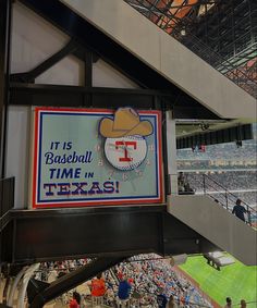 a sign hanging from the side of a building that says it is baseball time in texas